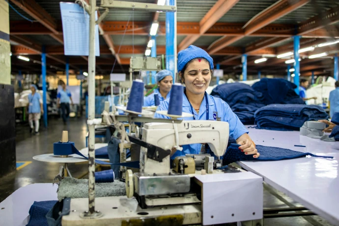 Workers are sewing clothes in a factory.